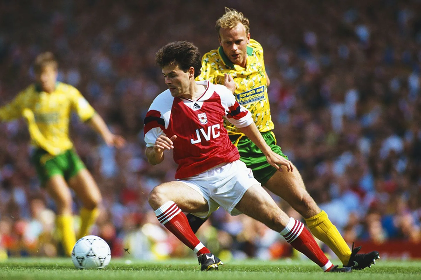 Arsenal and Norwich City players contest the ball on the Premier League's opening day in 1992